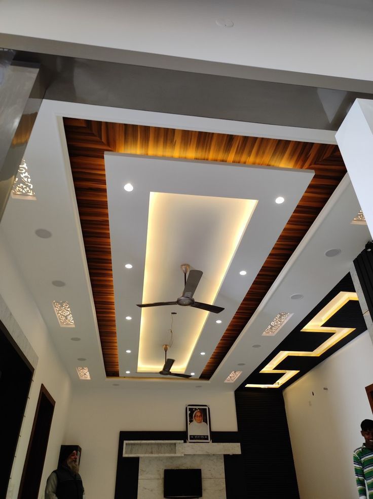 PVC Fall Ceiling - A layered PVC ceiling with warm wooden accents and LED strip lighting.. by Aamir Enterprises S, POP Ceiling & False Ceiling Contractor in Bhopal, Madhya Pradesh