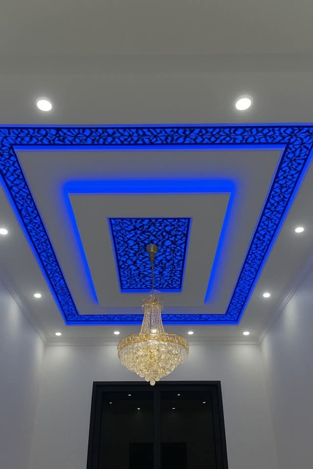 Designer panels Ceiling - A bold ceiling design with layered geometric shapes illuminated by blue LED lighting.. by Aamir Enterprises S, POP Ceiling & False Ceiling Contractor in Bhopal, Madhya Pradesh
